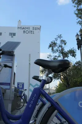 a blue bike parked in front of a gas station at Miami Sun Hotel - Downtown/Port of Miami in Miami
