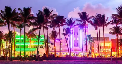 a building with palm trees in front of it at Oceanview Private Condo at 1 Hotel & Homes -1144 in Miami Beach