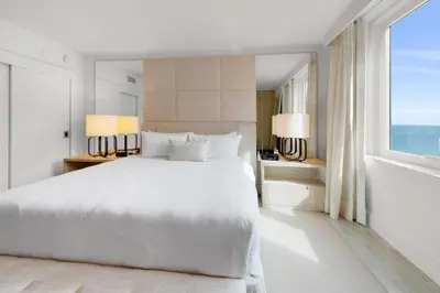 a bedroom with a white bed and a large window at Oceanview Private Condo at 1 Hotel & Homes -1408 in Miami Beach