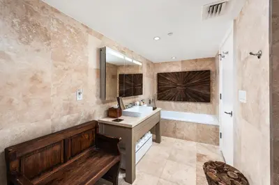 a bathroom with a sink and a tub and a mirror at Oceanview Private Condo at 1 Hotel & Homes -1408 in Miami Beach