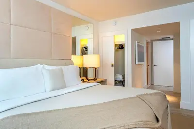 a bedroom with a large white bed and two lamps at Oceanview Private Condo at 1 Hotel & Homes -1106 in Miami Beach