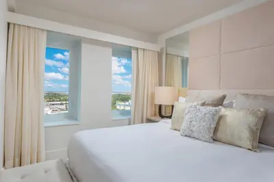 a white bedroom with a large bed and windows at Luxurious Private Condo at 1 Hotel & Homes -1445 in Miami Beach