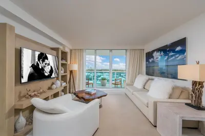 a living room with a white couch and a tv at Luxurious Private Condo at 1 Hotel & Homes -1445 in Miami Beach