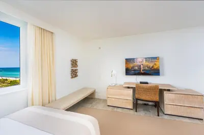 a bedroom with a desk and a bed and a window at Oceanview Private Condo at 1 Hotel & Homes -1015 in Miami Beach