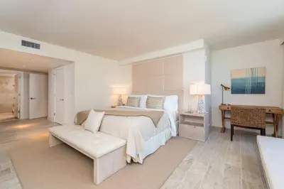 a white bedroom with a large bed and a table at Oceanview Private Condo at 1 Hotel & Homes -1015 in Miami Beach