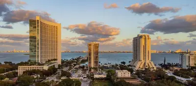 a group of tall buildings next to the water at Up Midtown in Miami