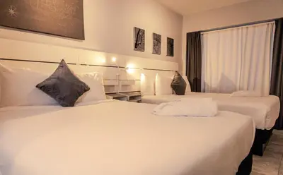 a hotel room with two beds and a window at Up Midtown in Miami
