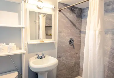 a white bathroom with a sink and a shower at Up Midtown in Miami