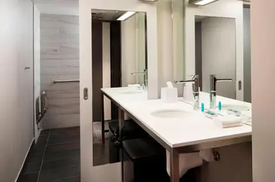 a bathroom with a sink and a mirror at Aloft Coral Gables in Miami