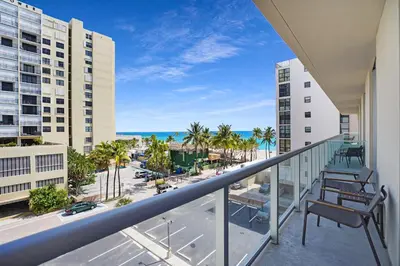 a balcony with a view of the beach and buildings at CH Luxury Condos & Studios On The Beach in Hollywood