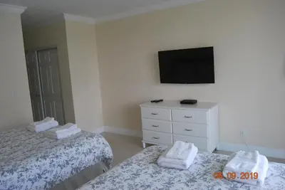 a bedroom with two beds and a tv on the wall at Ocean Reserve Piso 7 STR-310 in Miami Beach