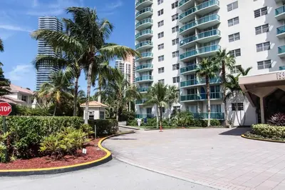 a street with palm trees and a stop sign in front of a building at Ocean Reserve Piso 7 STR-310 in Miami Beach