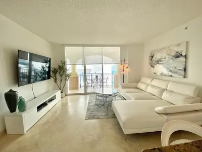 a living room with a white couch and a table at The King David Condos in Miami Beach
