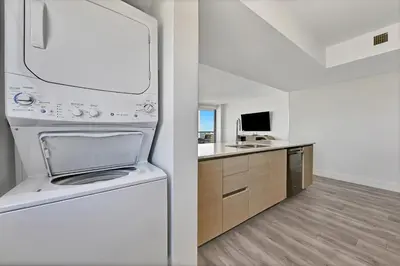 a kitchen with a white refrigerator and a sink at Three-Bedroom Beachwalk Resort Apartment in Hallandale Beach