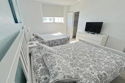 a bedroom with two beds and a flat screen tv at THE TIDES 2 bedrooms 9th floor WE ARE ON THE BEACH! in Hollywood