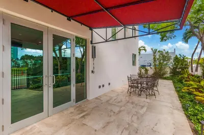 a patio with chairs and tables in a house at Costa Norte Boutique Hotel Miami Beach in Miami Beach