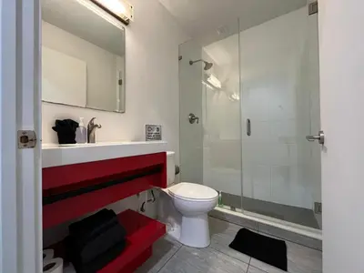 a bathroom with a toilet and a glass shower at Costa Norte Boutique Hotel Miami Beach in Miami Beach