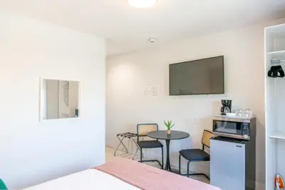 a room with a bed and a table and a tv at Costa Norte Boutique Hotel Miami Beach in Miami Beach