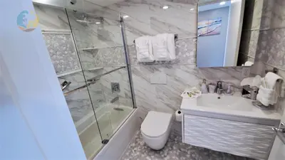 a bathroom with a shower and a toilet and a sink at Luxury Beach Resort - HORA RENTALS in Miami Beach