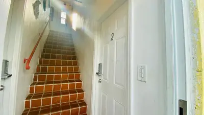 a stairway with a white door and a set of stairs at Hollywood Beachfront House in Hollywood