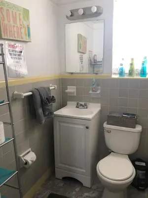 a bathroom with a white toilet and a sink at Hollywood Beachfront House in Hollywood
