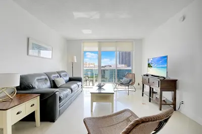 a living room with a couch and a desk at 2 BEDROOMS 2 FULL BATHROOMS APT. ON THE BEACH in Hollywood