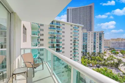 a balcony with chairs and a view of the city at 2 BEDROOMS 2 FULL BATHROOMS APT. ON THE BEACH in Hollywood