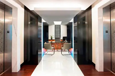 a hallway with a table and chairs in a building at Hotel Beaux Arts, Autograph Collection in Miami