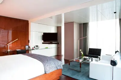 a bedroom with a white bed and a tv at Hotel Beaux Arts, Autograph Collection in Miami