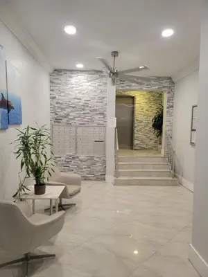 a lobby with chairs and a stone wall at King condo Fort Lauderdale Central beach in Fort Lauderdale