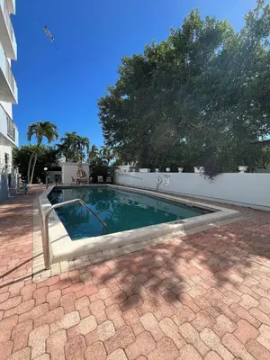 a swimming pool in the middle of a brick yard at King condo Fort Lauderdale Central beach in Fort Lauderdale