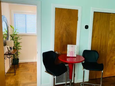 a room with a red table and two chairs at Blue House Miami in Miami Beach