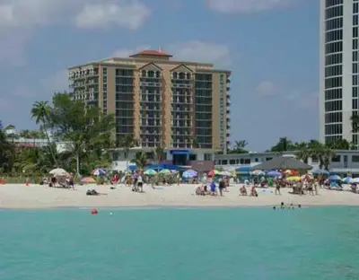 a group of people on a beach with buildings at King David Condominium Sunny Isles Beach in Miami Beach