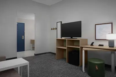 a room with a tv and a desk with a computer at Spark by Hilton Miami Doral in Miami