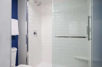 a bathroom with a shower with a glass door at Spark by Hilton Miami Doral in Miami