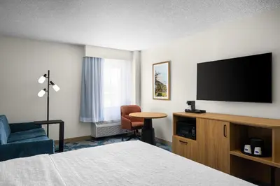 a hotel room with a bed and a flat screen tv at Hampton Inn Miami-Airport West in Miami