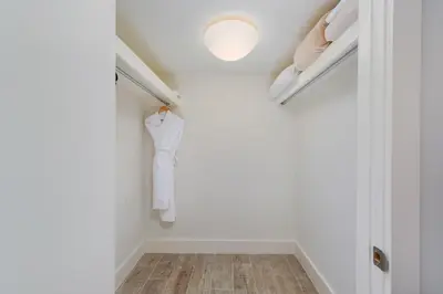 a walk in closet with a white wall at Oceanview Private Condo at 1 Hotel & Homes -1122 in Miami Beach