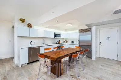 a kitchen with a wooden table and chairs at Oceanview Private Condo at 1 Hotel & Homes -1122 in Miami Beach
