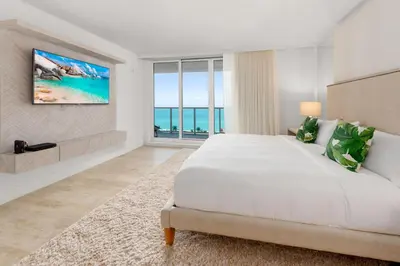 a white bedroom with a large bed and a large window at Oceanview Private Condo at 1 Hotel & Homes -1122 in Miami Beach
