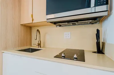 a kitchen with a sink and a microwave at Green Island Inn in Fort Lauderdale