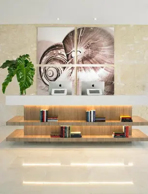 a book shelf with books on it in a room at Grand Beach Hotel Bay Harbor in Miami Beach
