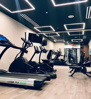 a gym with several treadmills and elliptical machines at Wyndham Garden Ft Lauderdale Airport & Cruise Port in Dania Beach