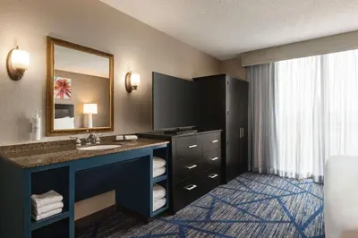 a bathroom with a sink and a mirror at Embassy Suites by Hilton Miami International Airport in Miami