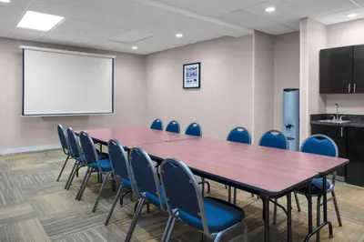 a conference room with a table and chairs and a whiteboard at Hampton Inn Miami/Dadeland in South Miami