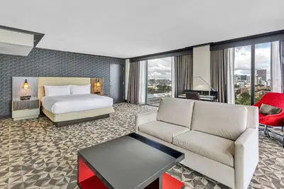 a hotel room with a bed and a couch at Hilton Miami Downtown in Miami