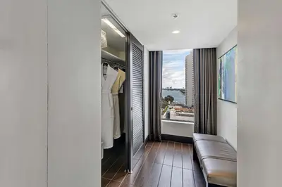 a hallway with a couch and a window with a view at Hilton Miami Downtown in Miami