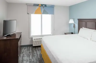 a hotel room with a bed and a flat screen tv at Hampton Inn & Suites Miami-Doral Dolphin Mall in Miami