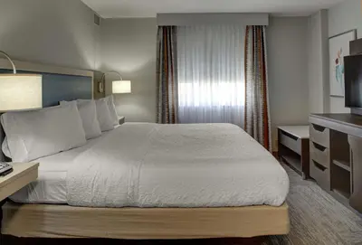 a hotel room with a bed and a television at Hampton Inn & Suites Miami Airport South/Blue Lagoon in Miami
