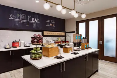 a kitchen with a counter with food on it at Hampton Inn & Suites Miami Airport South/Blue Lagoon in Miami