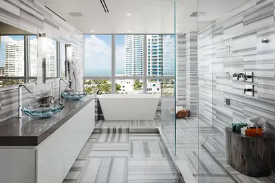 a bathroom with a tub and a large window at Hilton Bentley Miami South Beach in Miami Beach